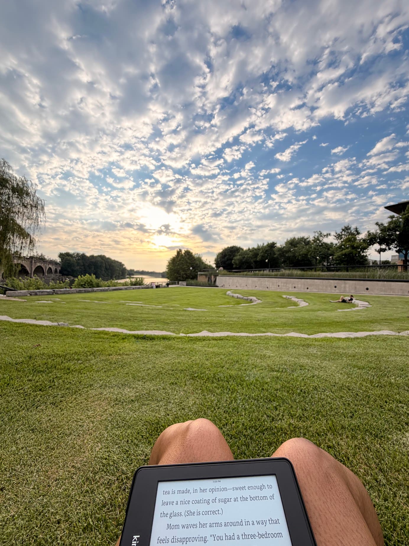Reading by the river at sunset